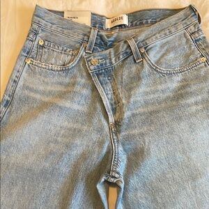 AGOLDE Crisscross upsize Light Wash Denim Jeans in suburbia.